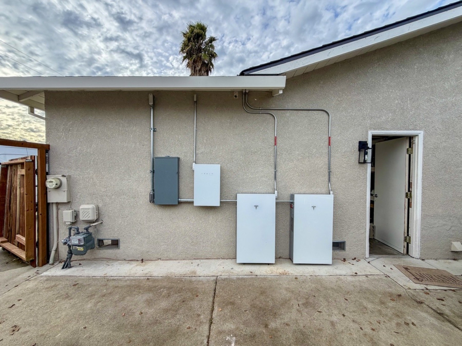 Two Tesla Powerwall 3 units, Backup Gateway, electrical panel, and conduit installed at a Livermore home
