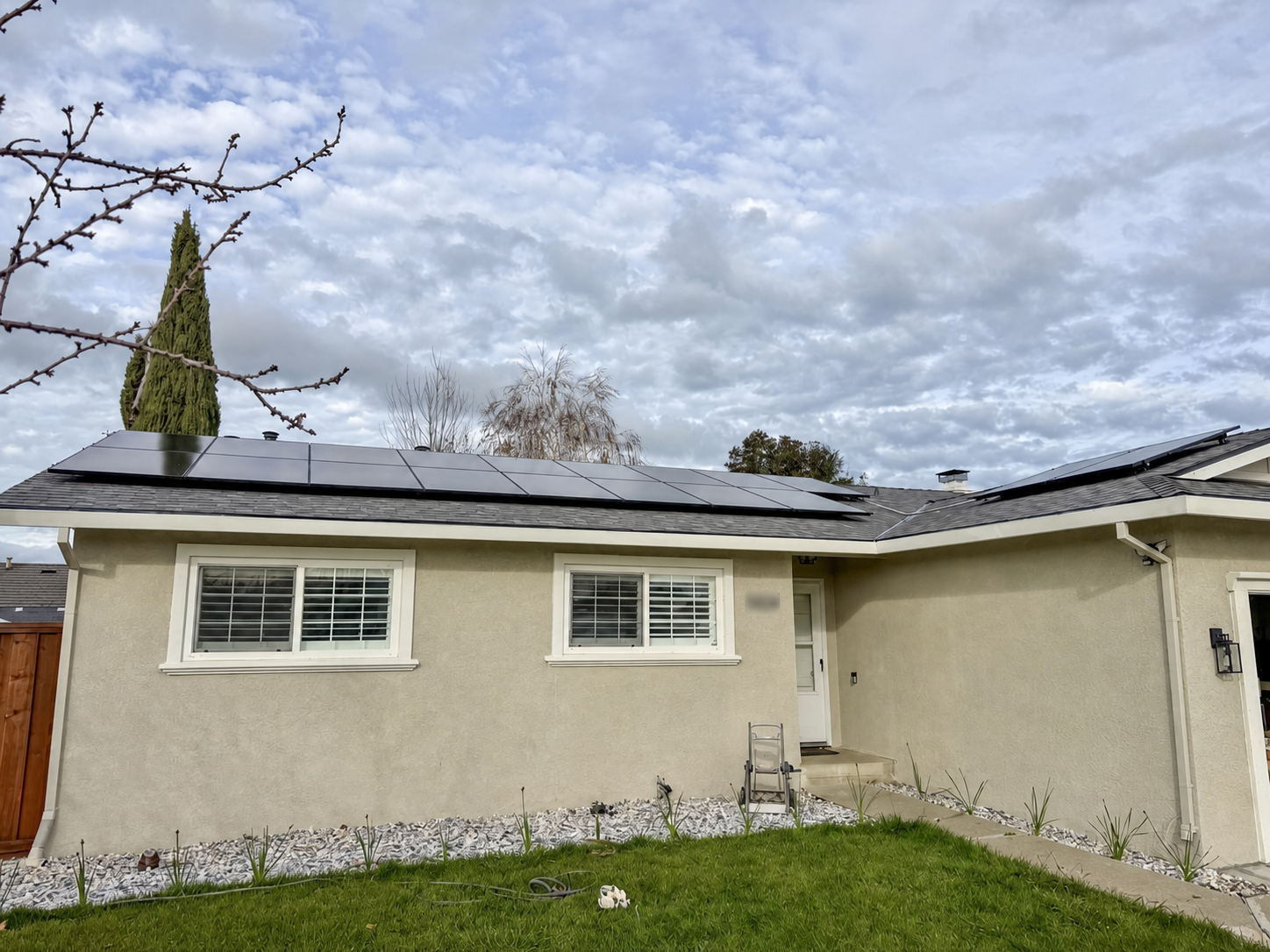 Front of a Livermore home with rooftop solar and the street number blurred for privacy
