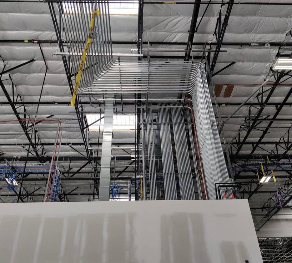 Parallel conduit runs above a commercial interior build-out