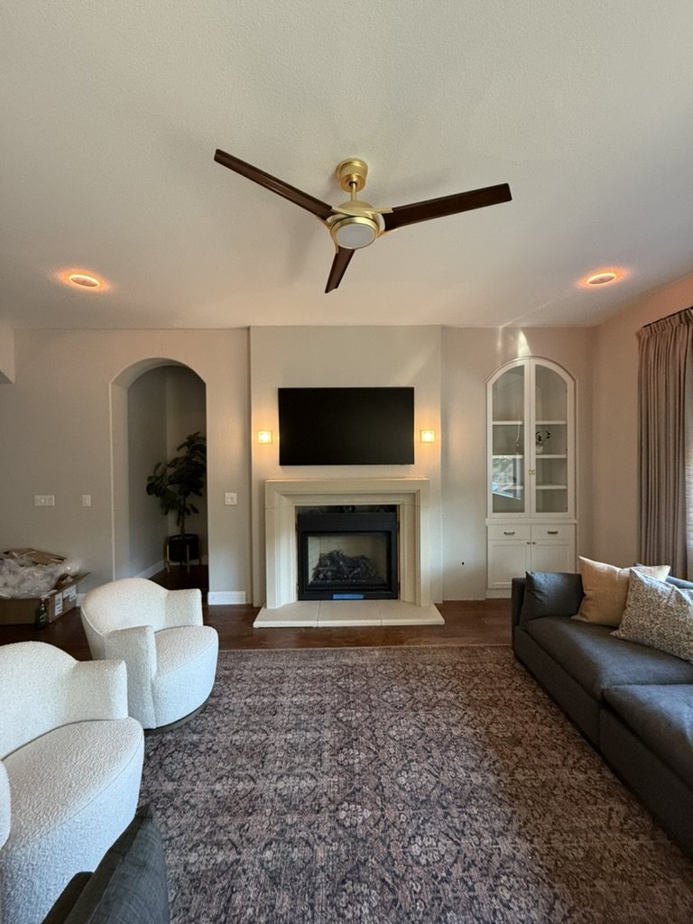 Finished living room with recessed lighting, wall sconces, and a ceiling fan